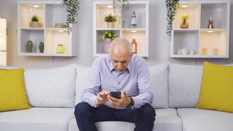 The-Old-Man-is-looking-at-the-phone.-The-old-man-uses-social-media.